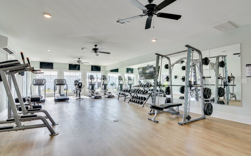exercise equipment in a gym with wood floors