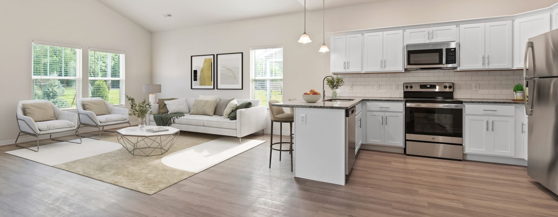 kitchen and living area with an island and bright, natural lighting